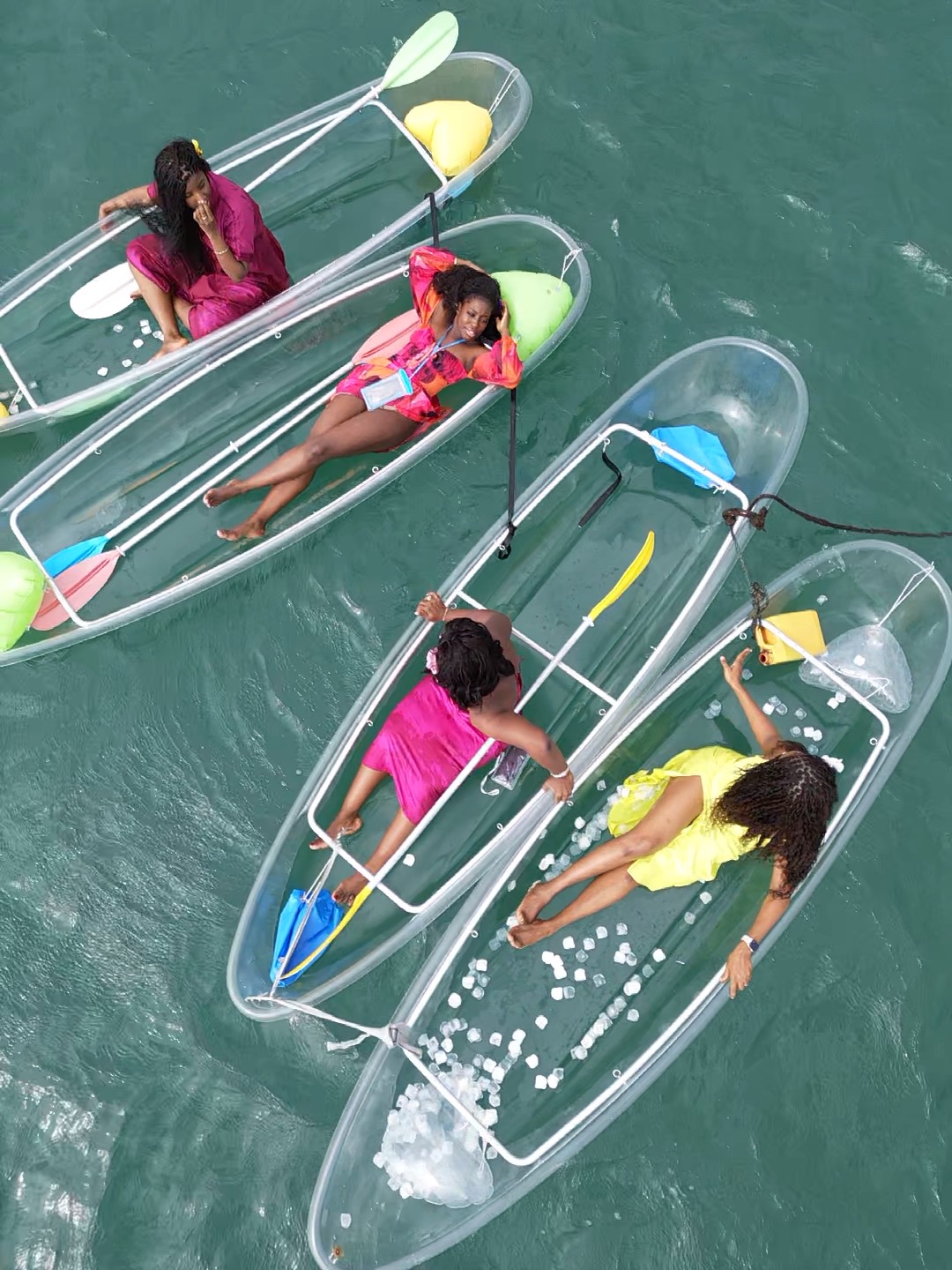 Group of friends in colourful outfits in clear kayaks in Ouakam - Water activities with friends Dakar, Senegal Nautique