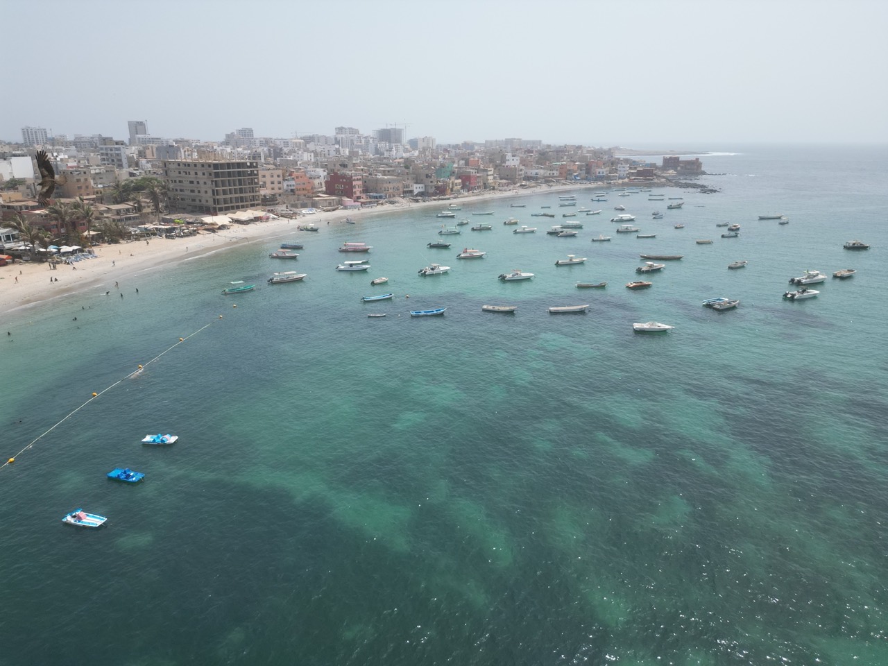 Ngor bay with boats, kayaks and turquoise water seen from a drone - Water activities Dakar, Senegal Nautique