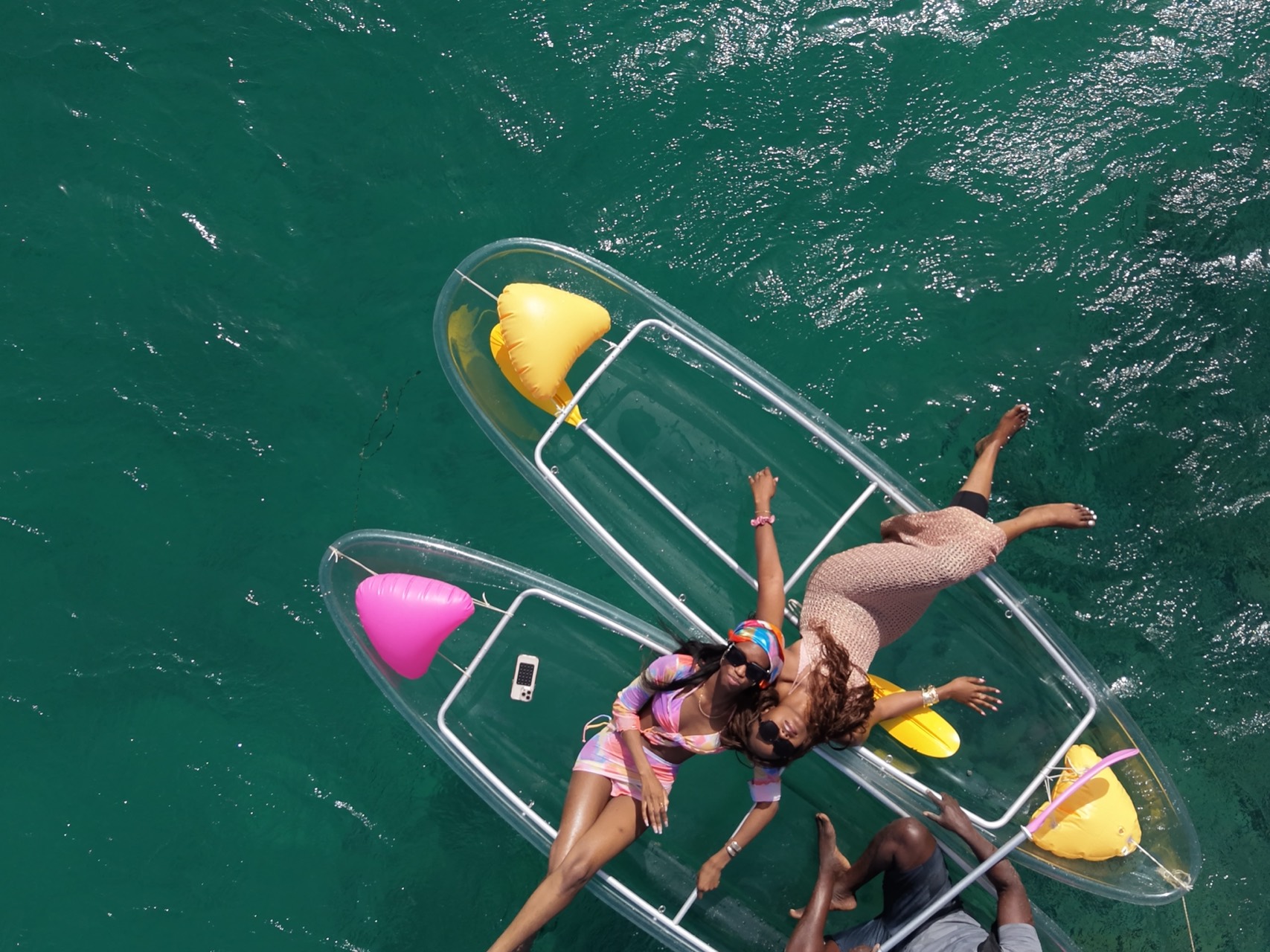 Two friends lying in their clear kayaks above the turquoise water of Ouakam - Clear kayak Ouakam, Senegal Nautique