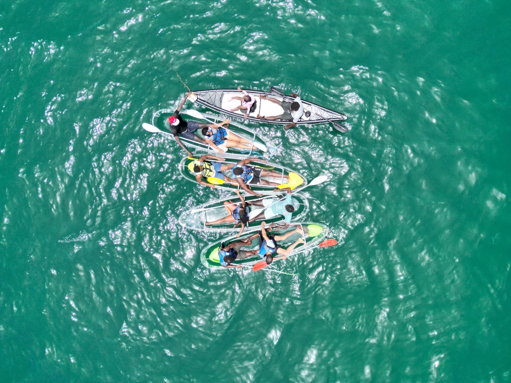 Fleet of clear kayaks on the turquoise water of Ouakam - Water tourism Dakar, Senegal Nautique
