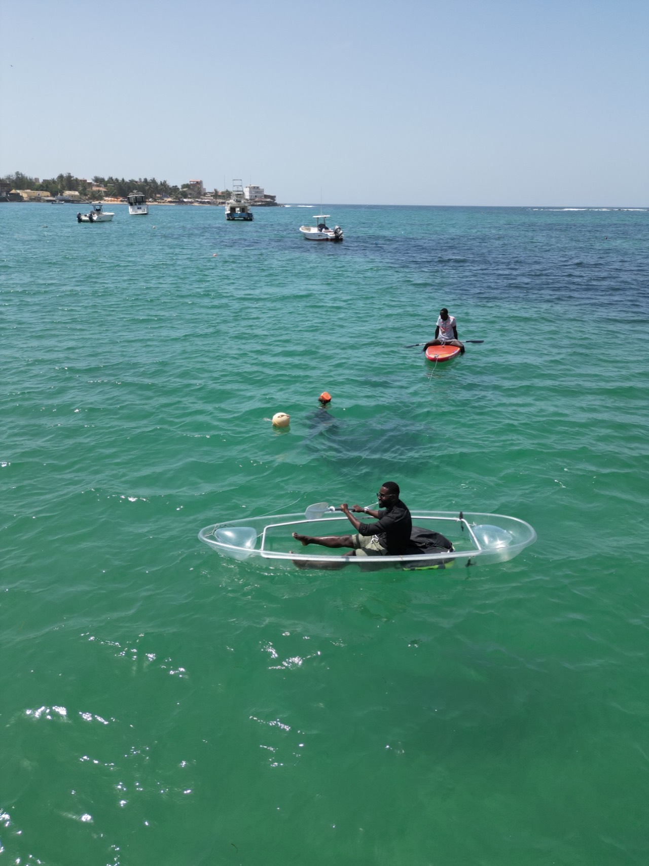 Kayaker in a clear kayak facing Ngor Island - Clear kayak Ngor, Senegal Nautique